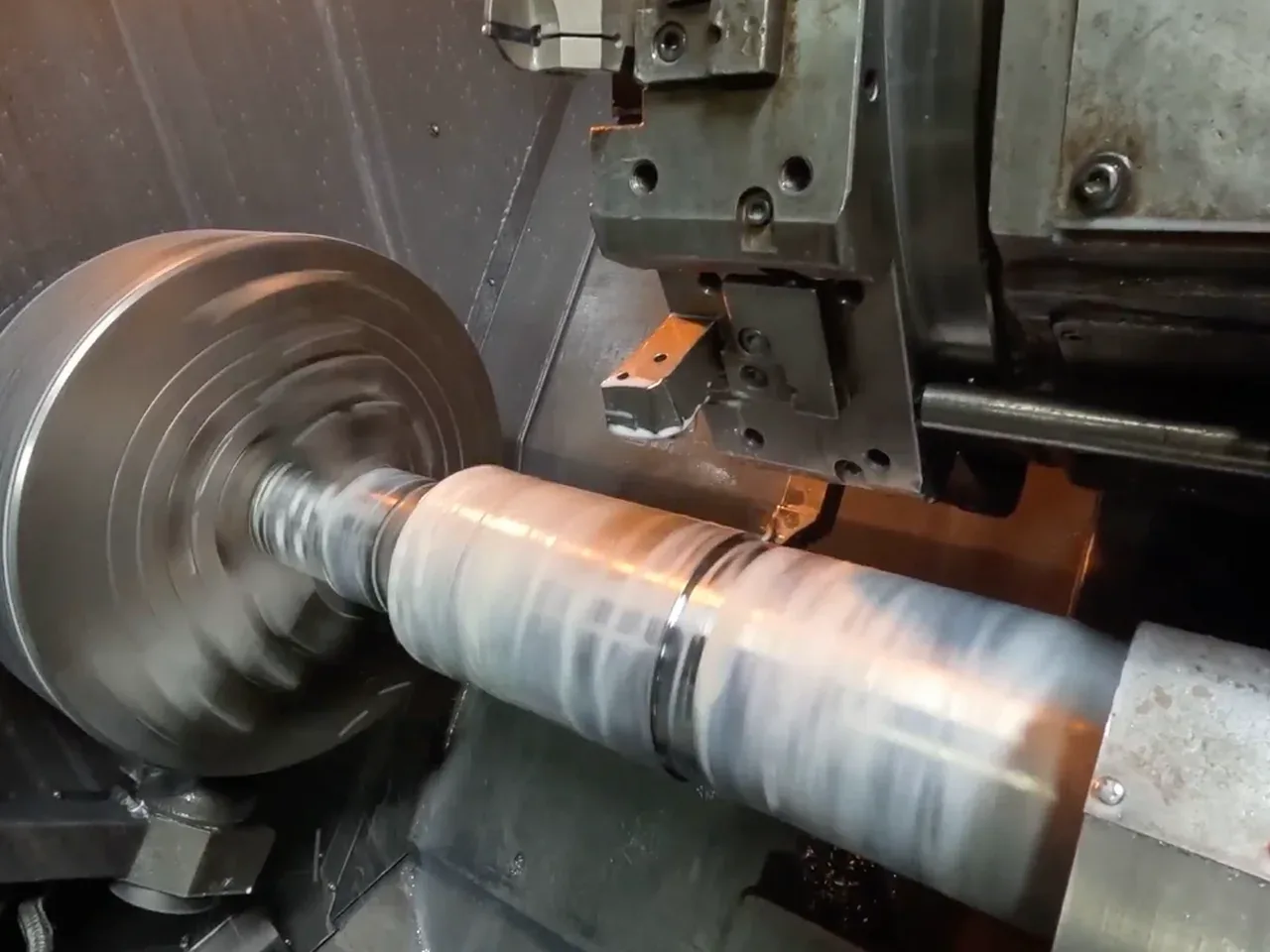 A spare part being machined on a CNC lathe (e.g. piston / cylinder)